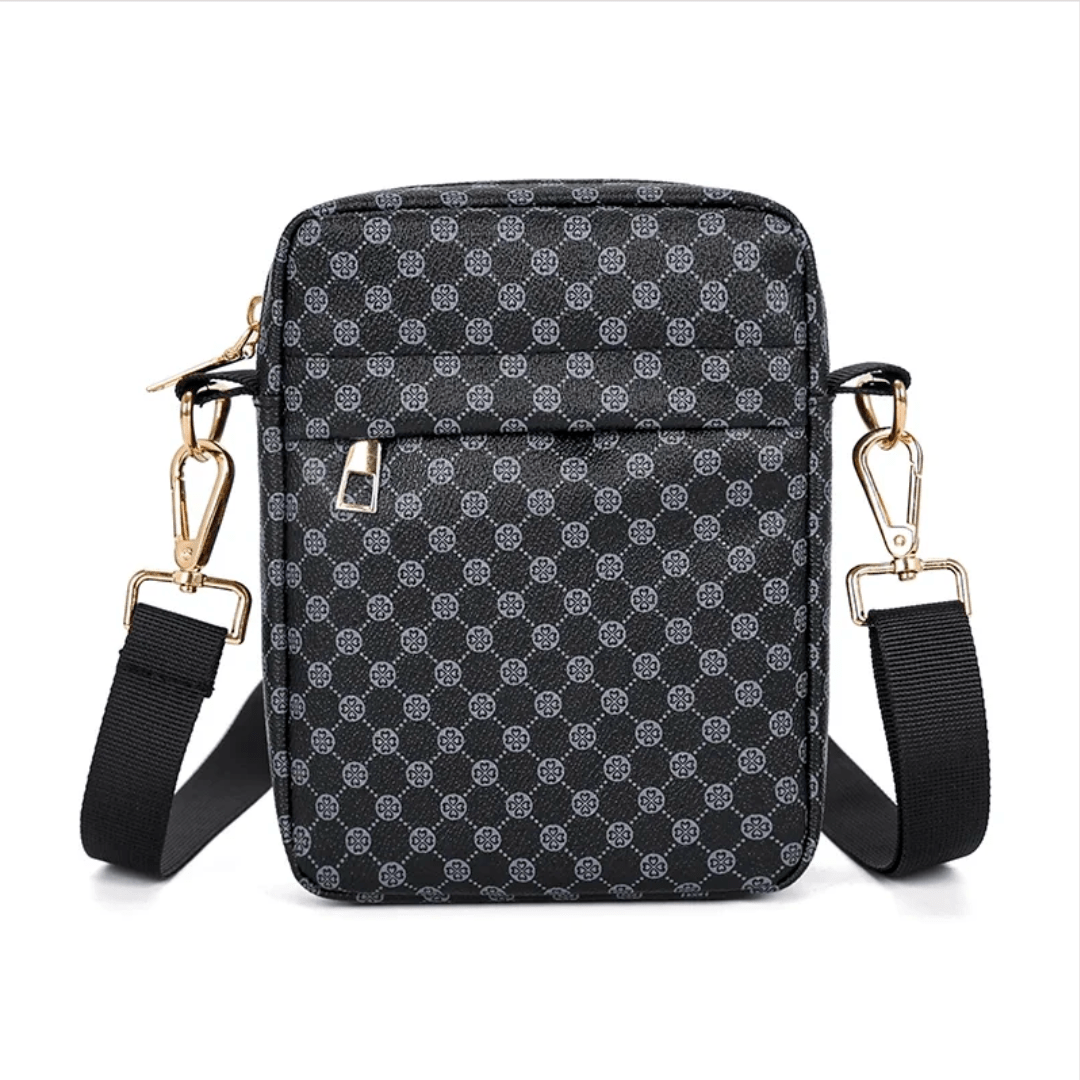 Black patterned crossbody bag with gold accents on a white background